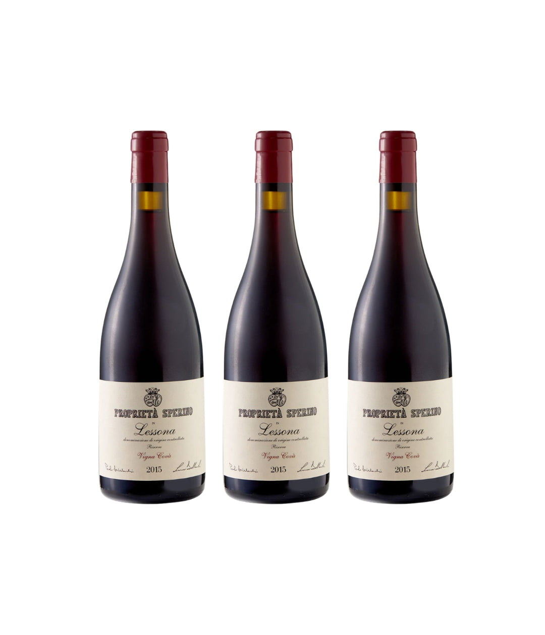 Three dark glass wine bottles with cream labels and red capsules, arranged side by side on a plain white background. The labels read &