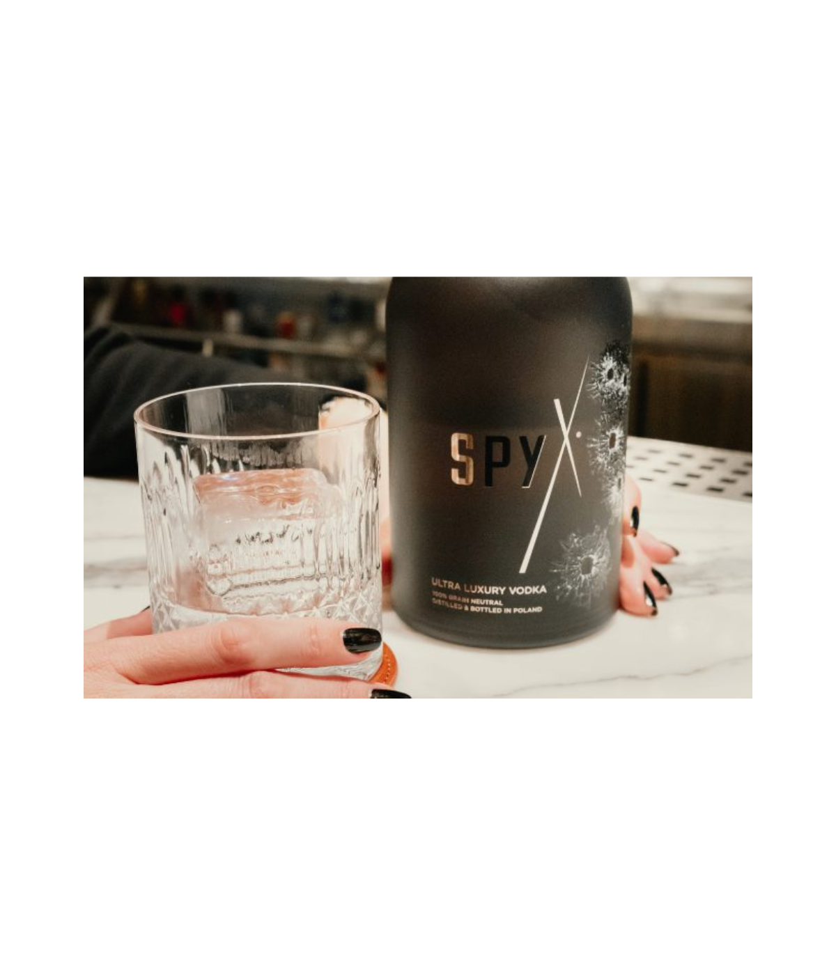 Spy ultra luxury vodka bottle with a glass on a table