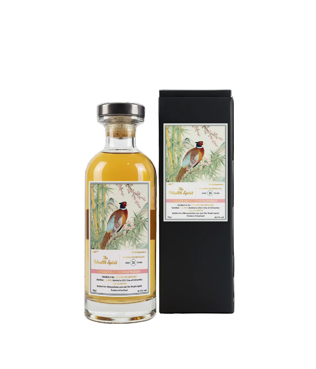 Bottle of whisky with decorative label featuring birds, next to a black box with similar design.